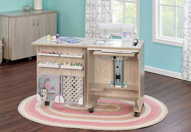 Compact sewing cabinet with built-in storage and sewing machine on a round braided rug