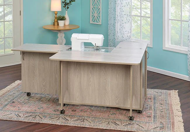 Expanded sewing cabinet with built-in sewing machine in a bright room