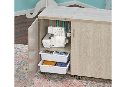 Sewing cabinet with an open door revealing a serger machine and storage trays