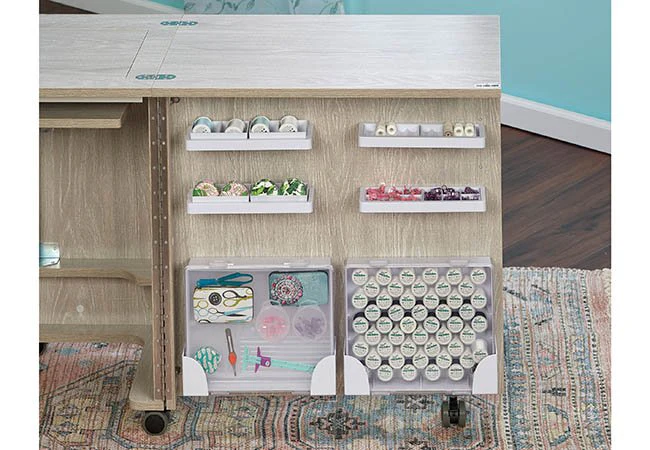 Sewing cabinet door with organized thread spools and accessory storage