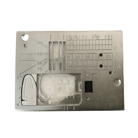 Close-up of a sewing machine needle plate with measurement markings