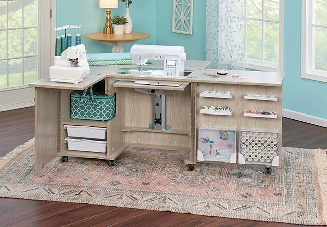 Spacious sewing workstation with organized storage, multiple sewing machines, and craft supplies