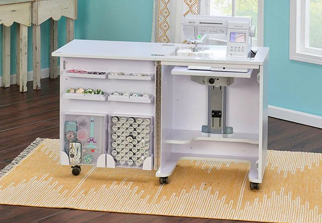 White sewing cabinet with storage compartments and sewing machine on a patterned yellow rug